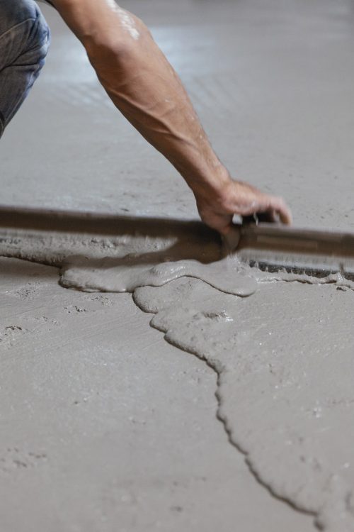 construction worker levelling liquid screed